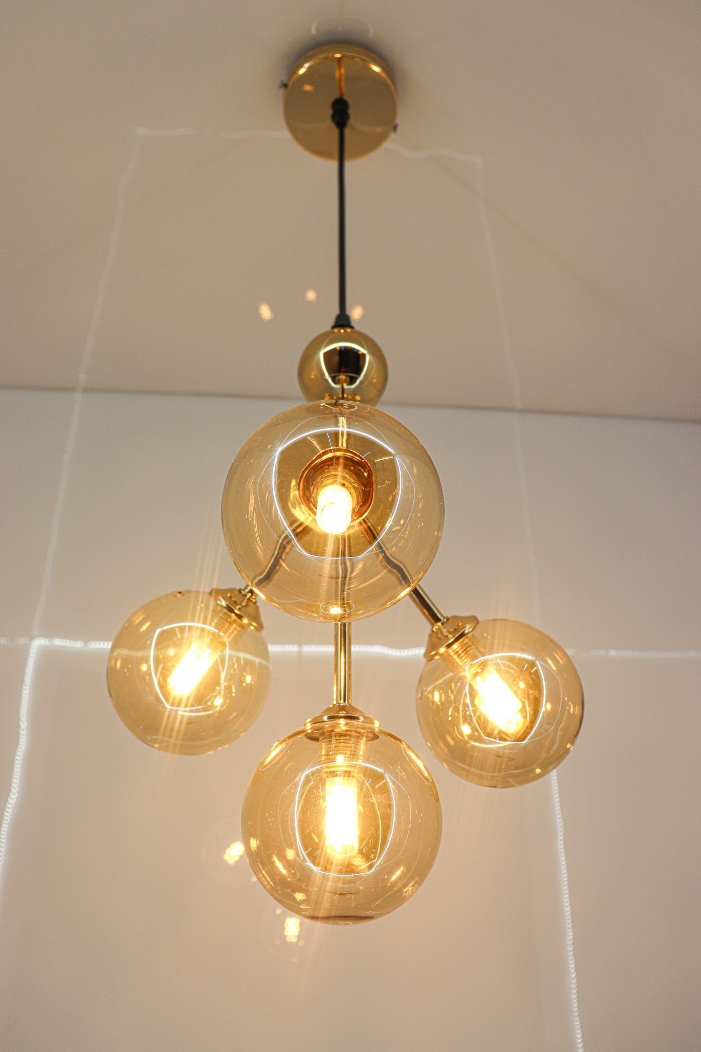 swanart Stunning Modern 4-Light Gold Ceiling Light Fixture | Mid-Century Chandelier with Amber Globe Glass Shades | Elegant Pendant Lighting for Living Room, Dining Room - Warm Ambiance Creator